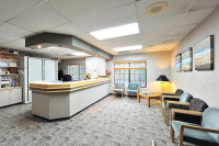 Bright and welcoming hotel lobby with reception desk and seating area.